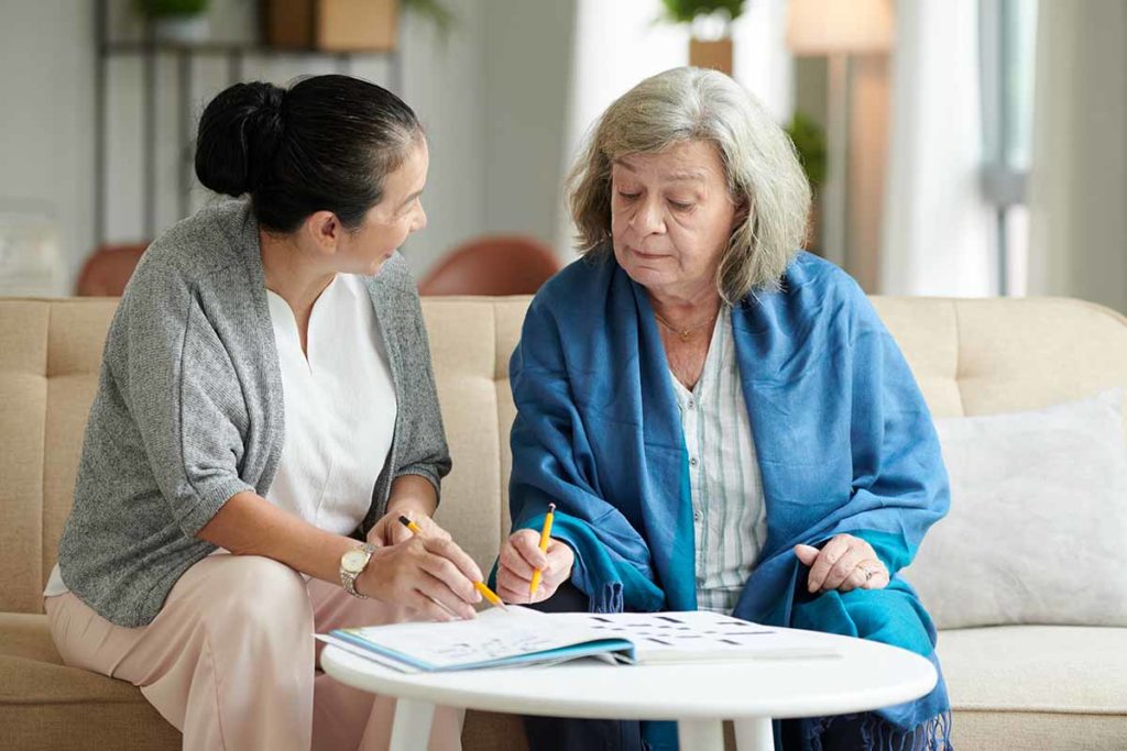 younger woman explaining to older woman what respite care for seniors entails