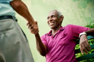 a man shakes the hand of someone offering skilled nursing care