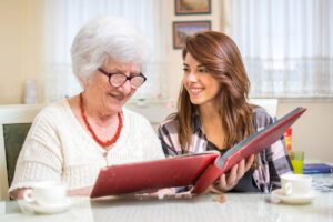 middle-aged daughter helping her mother come up with questions to ask a memory care community