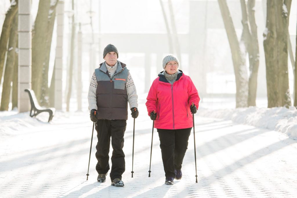 Seniors enjoying cross country skiing as a winter activity.