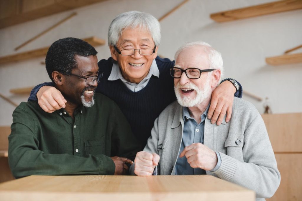 three senior citizens laughing together arm in arm while exploring 5 activities for seniors in respite care