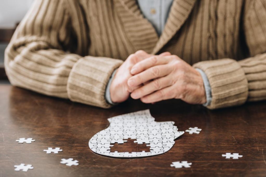 close up of a jigsaw puzzle being worked by a senior citizen who is undertaking one of 5 memory care activities for senior citizens