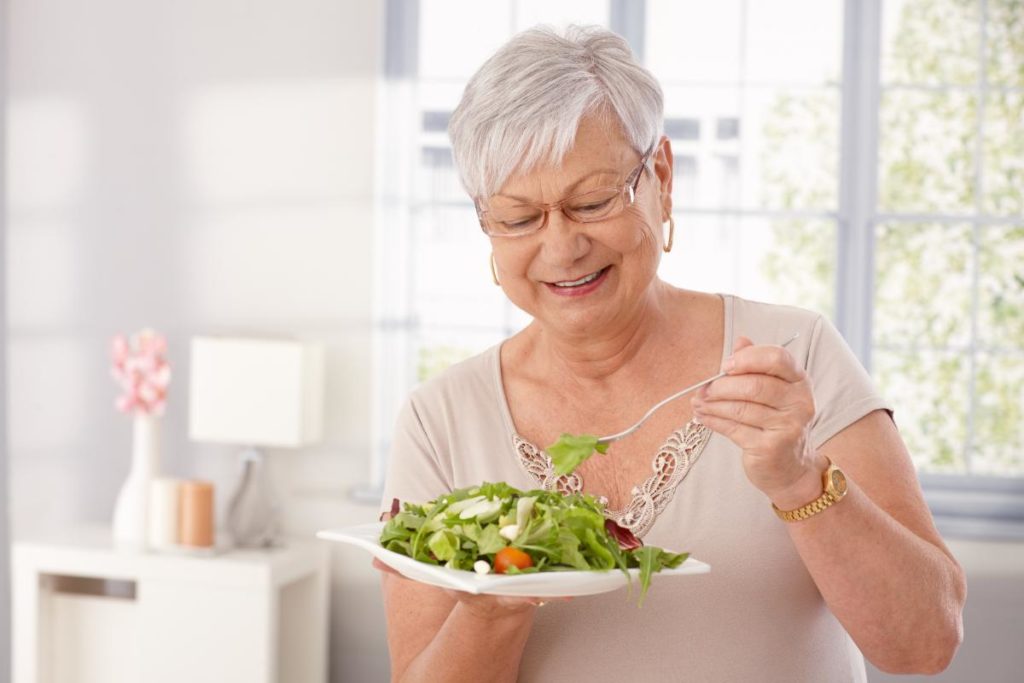 female senior citizen about to enjoy a healthy salad because she knows what's the best diet for senior citizens