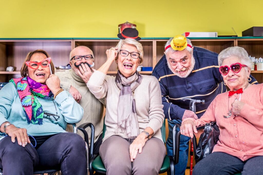 group of senior citizens in party hats enjoying one of 10 social activities for seniors this spring