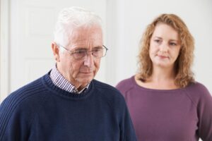 middle-aged woman looking at her father wondering when is it time to put a family member in memory care