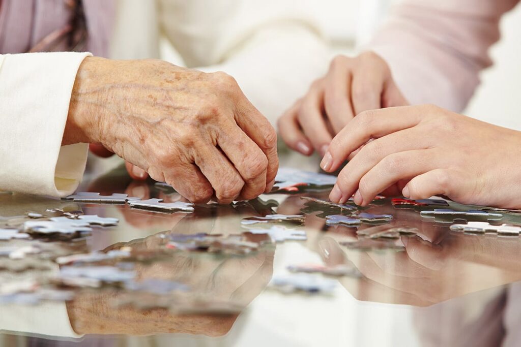 seniors do a puzzle to improve memory and concentration