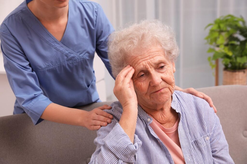 Older person overstimulated and being comforted by someone else