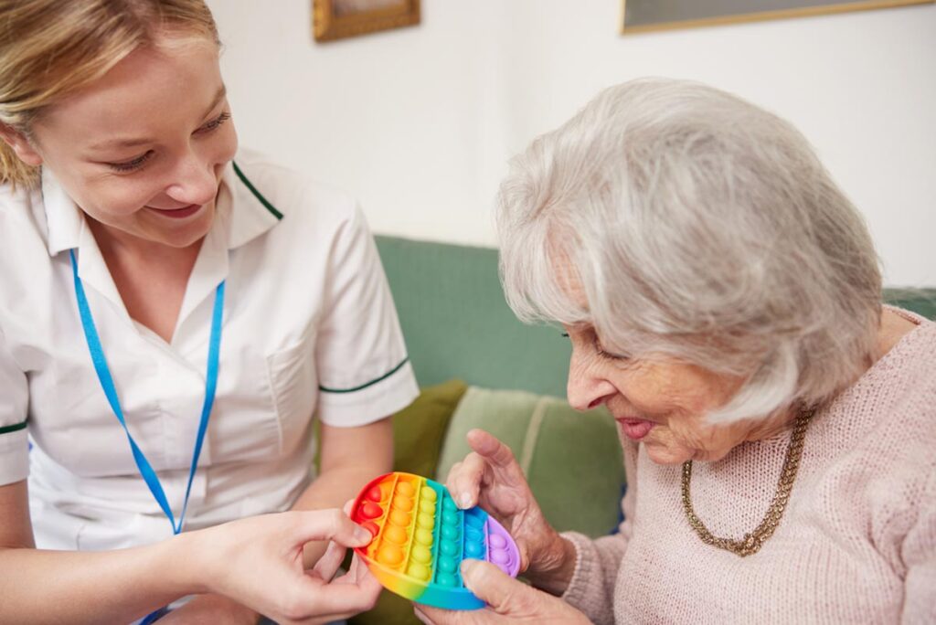 Older person and nurse in a session for sensory stimulation for dementia