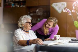 middle aged woman helping her elderly mother by asking what are frequently asked questions about respite care