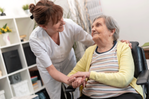 young female nurse helps elderly senior home resident by demonstrating the role of skilled nursing in managing chronic conditions in seniors