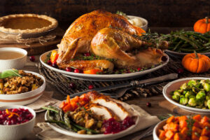 image of Thanksgiving feast laid out on a table as a reminder for virtual Thanksgiving celebration ideas for older adults living in a senior living community.