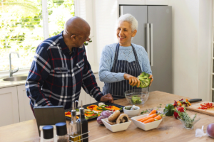 two senior citizens preparing nutritious food together as they discover how do senior living communities support healthy eating