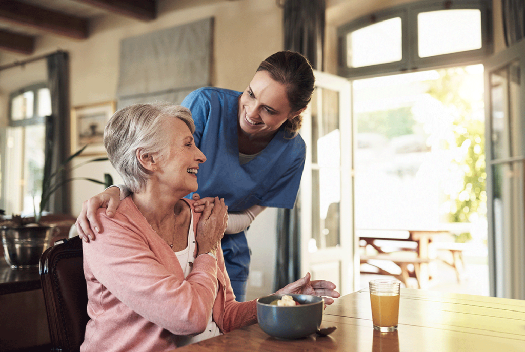 senior living community staff member talking to female resident about how can senior living communities help with managing chronic conditions.